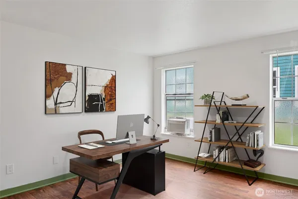 a view of a workspace with furniture and a window