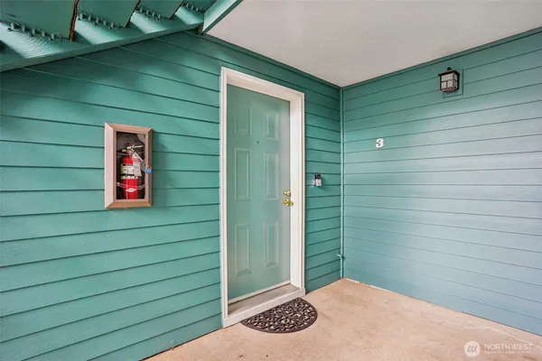 a view of a wooden door and brick wall