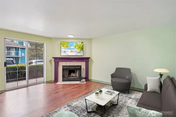 a living room with furniture and a fireplace