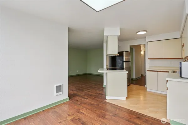 a kitchen with a refrigerator and a stove top oven