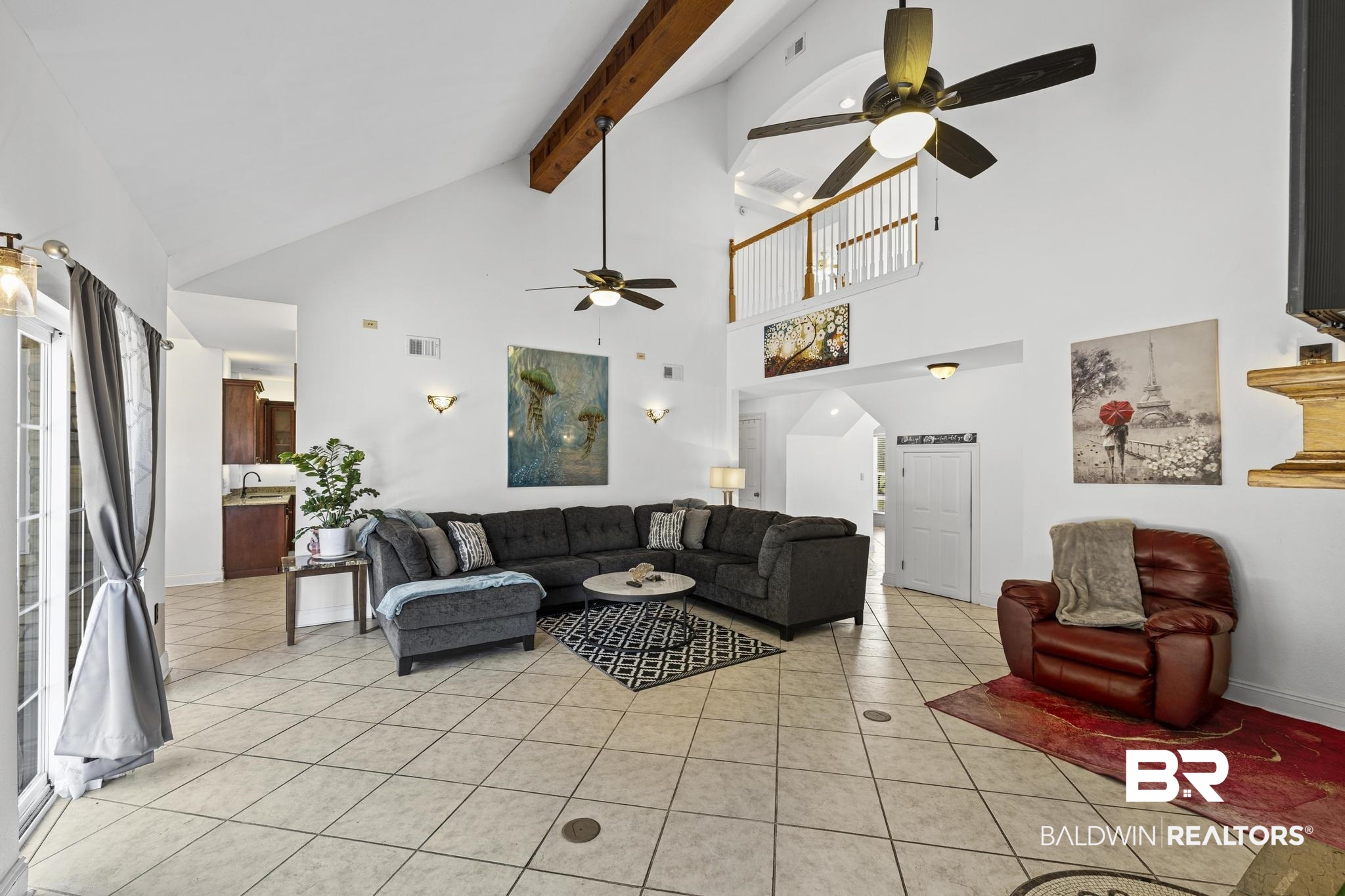32875 Faircloth Road Lillian, AL 36549 - Photo 29 of 85 Living area with ceiling fan, light tile patterned flooring, and vaulted ceiling