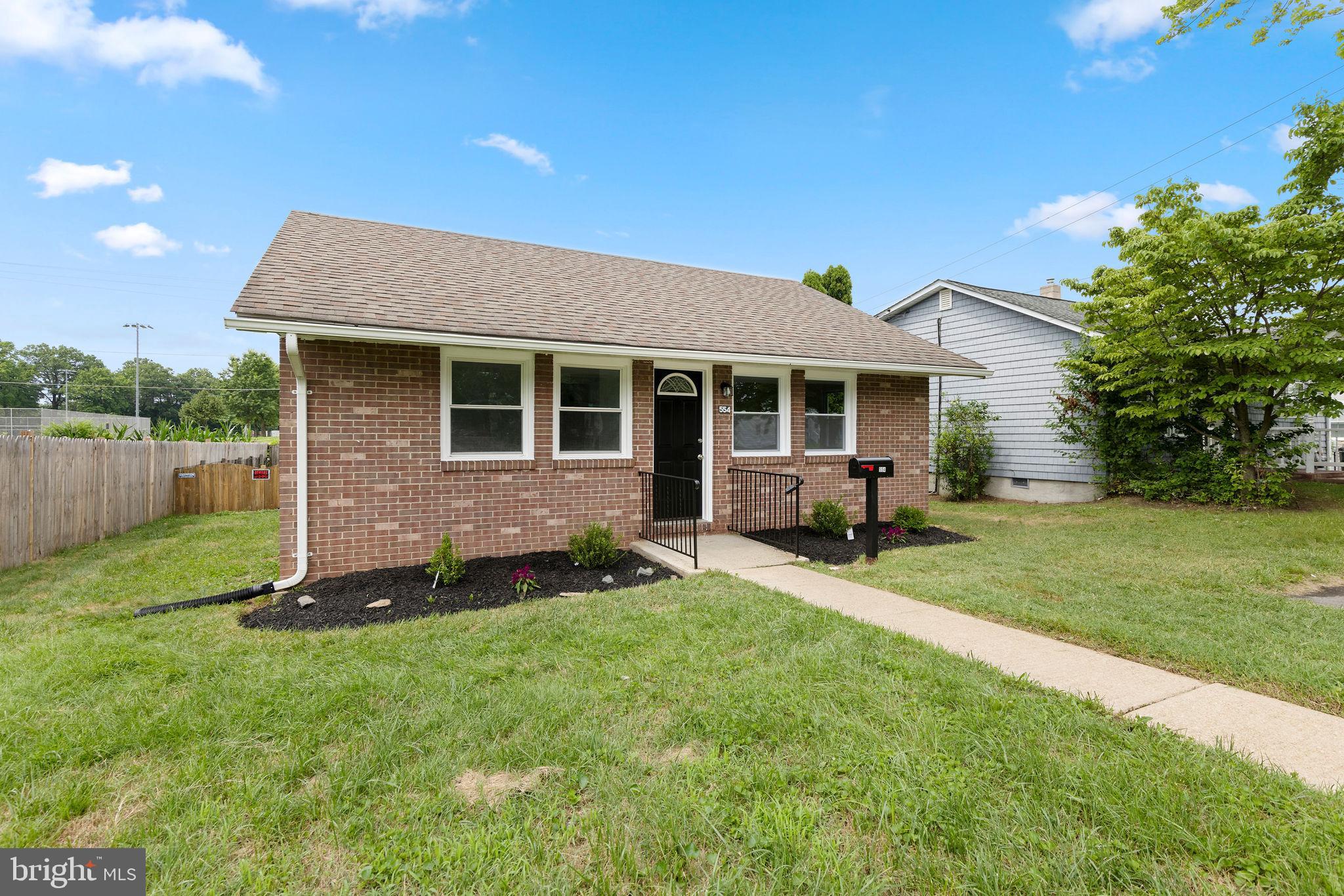 554 Compass Road East Baltimore, MD 21220 - Photo 1 of 24 a front view of a house with a garden