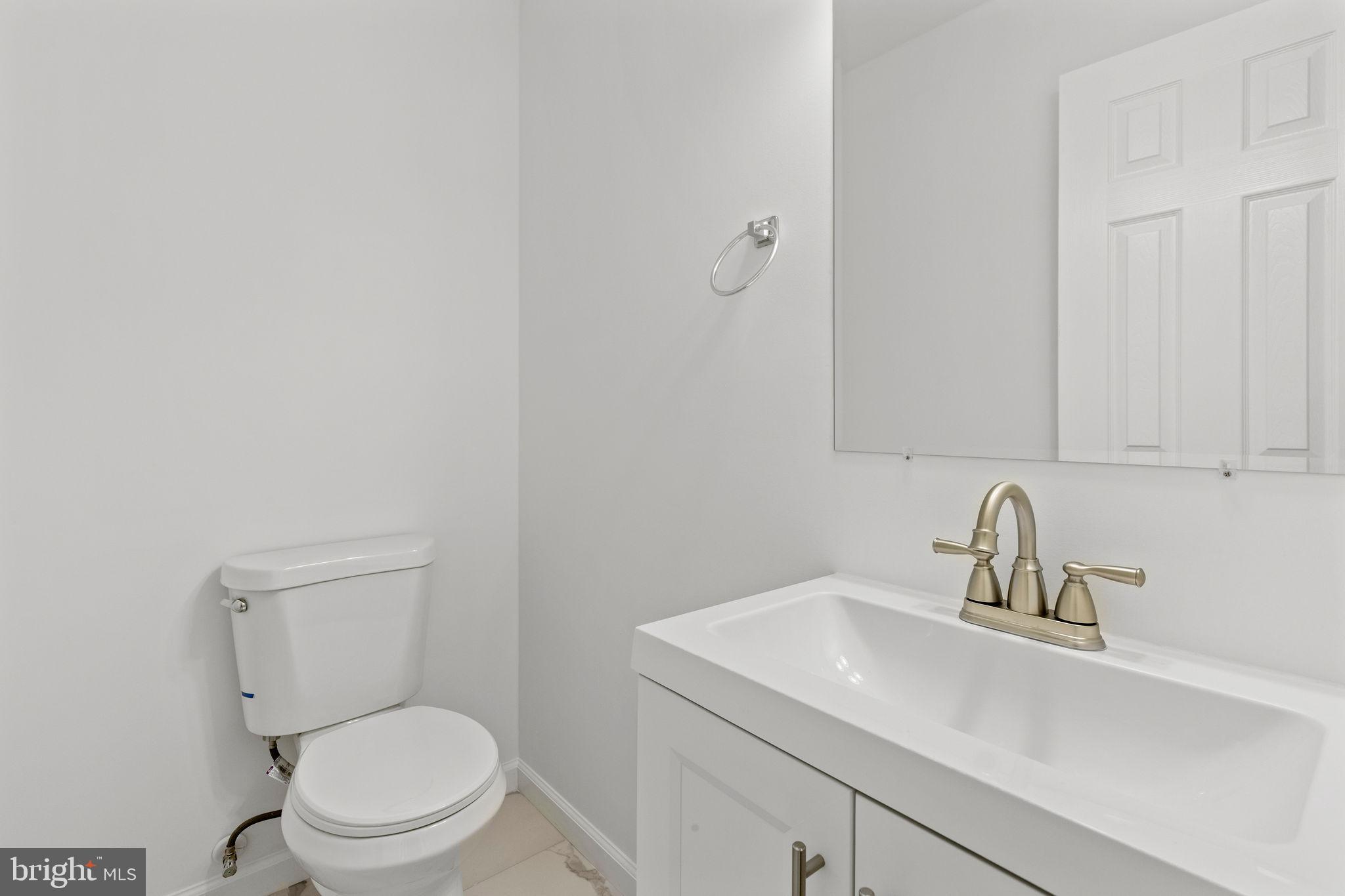 554 Compass Road East Baltimore, MD 21220 - Photo 19 of 24 a bathroom with a sink toilet and a mirror