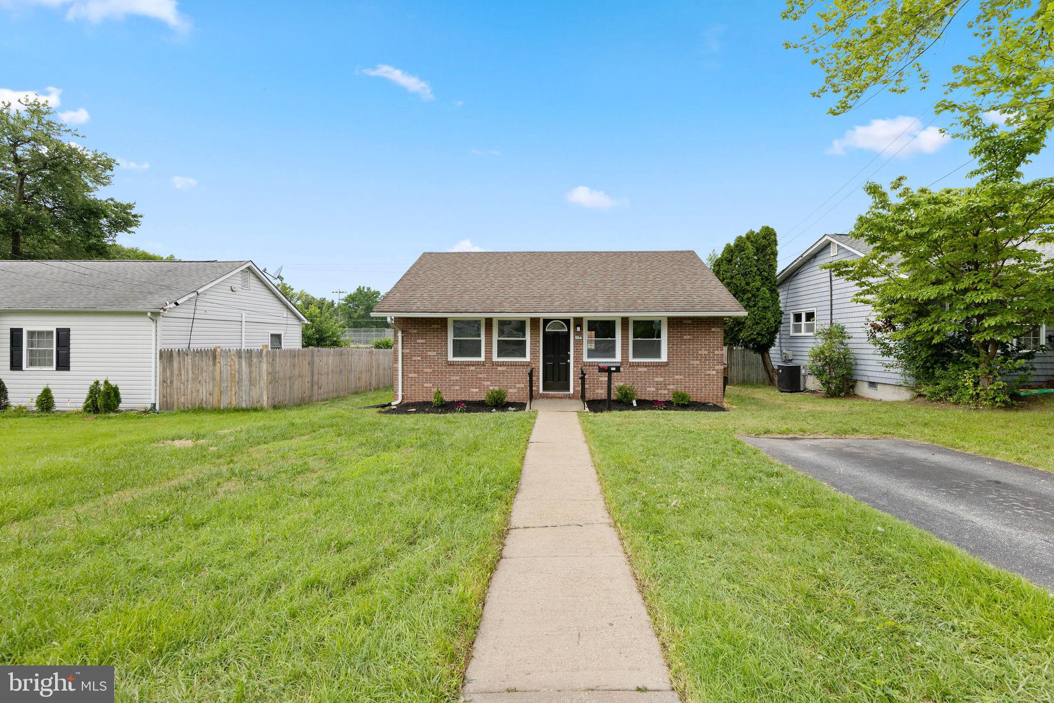 554 Compass Road East Baltimore, MD 21220 - Photo 3 of 24 a front view of a house with yard and green space