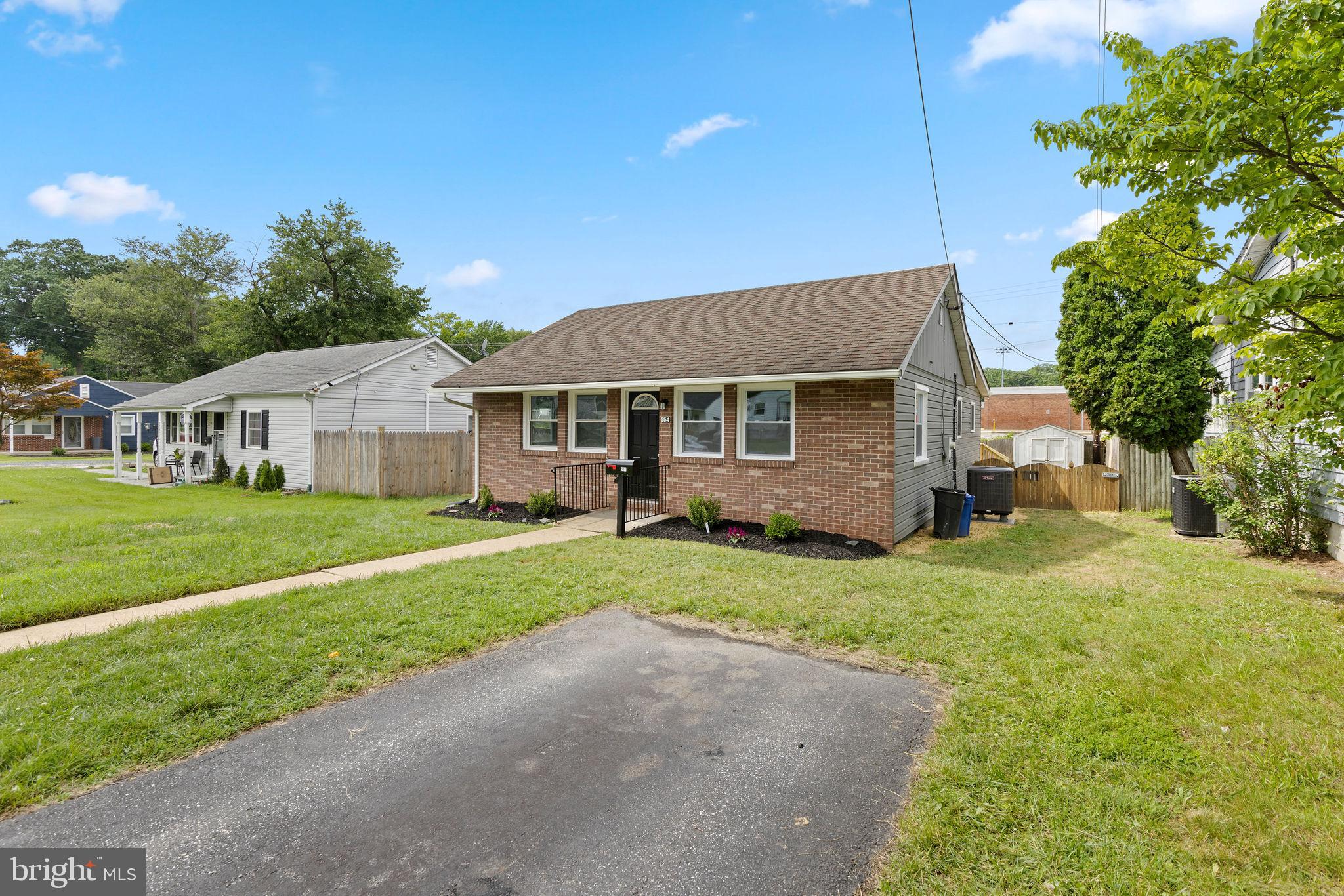 554 Compass Road East Baltimore, MD 21220 - Photo 5 of 24 a front view of a house with a yard