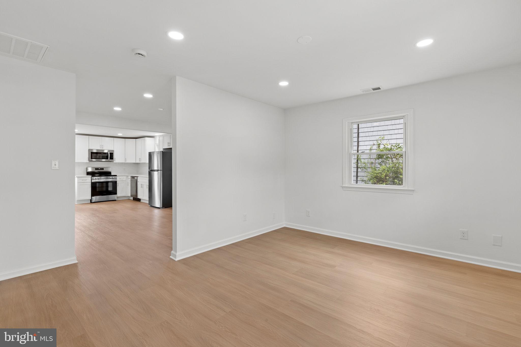 554 Compass Road East Baltimore, MD 21220 - Photo 6 of 24 wooden floor in an empty room with a window