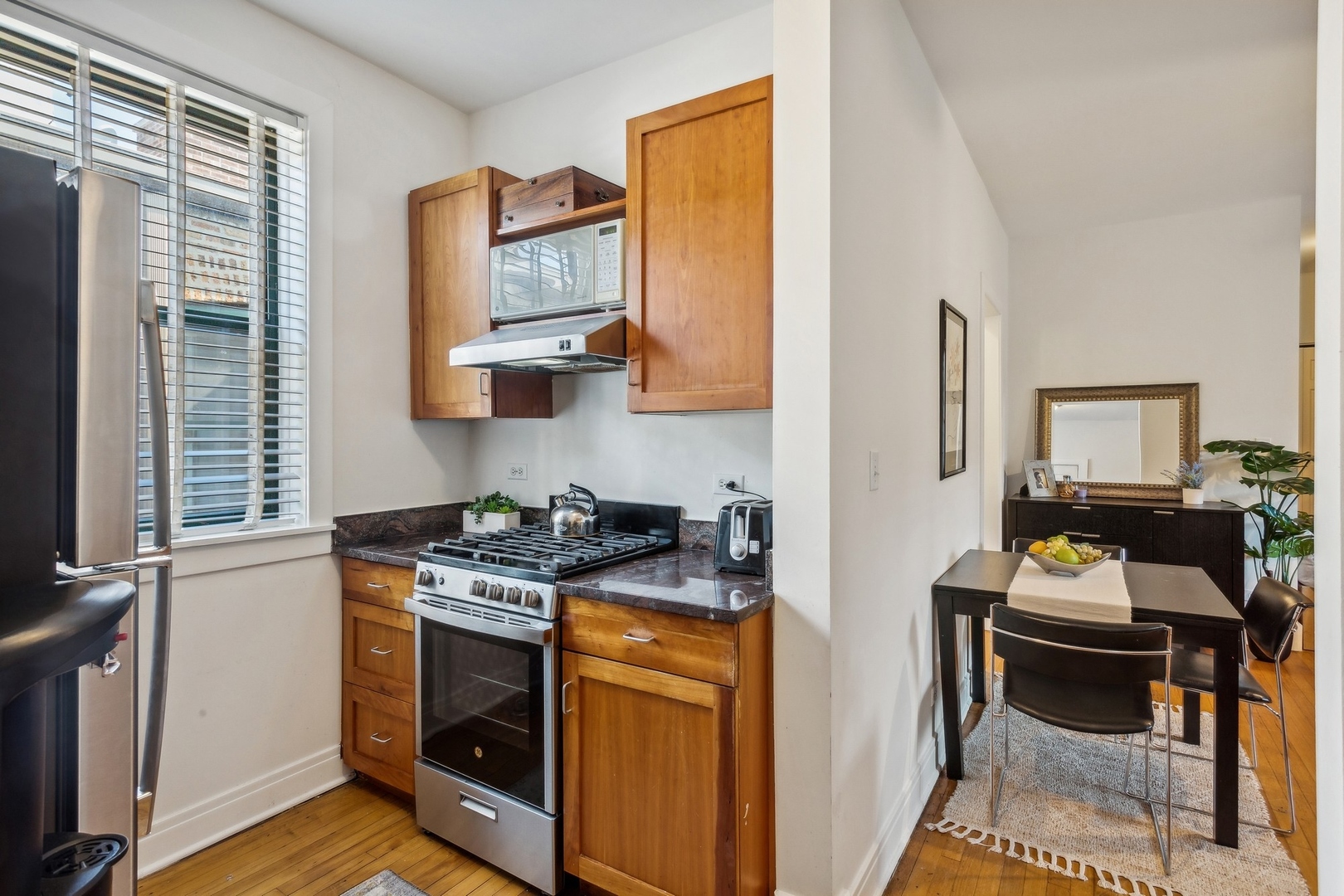 7025 North Sheridan Road, Unit 3N Chicago, IL 60626 - Photo 5 of 14 a kitchen with stainless steel appliances a stove a sink and a refrigerator