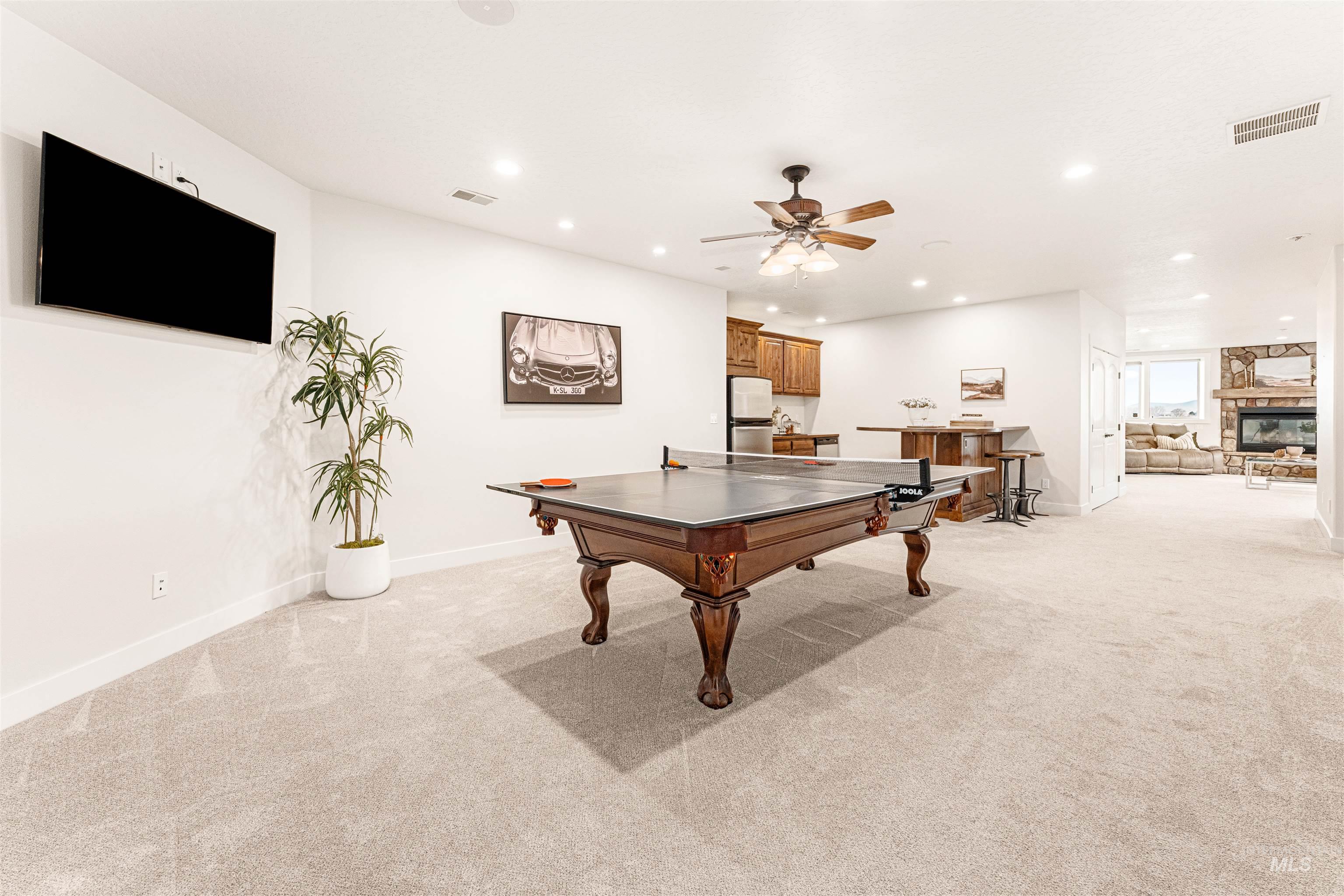4262 South Rustler Lane Meridian, ID 83642 - Photo 34 of 50 Game room with recessed lighting, a fireplace, light carpet, and a ceiling fan