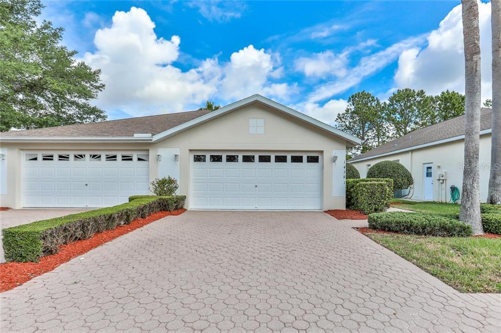 14381 Sterling Run Spring Hill, FL 34609 - Photo 1 of 1 a front view of a house with a yard and garage