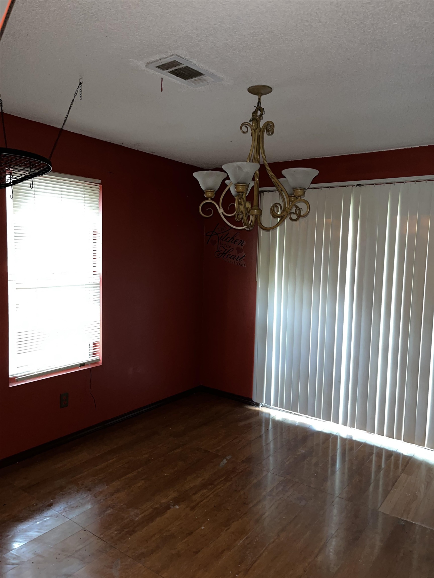 1685 Turner Road Grand Junction, TN 38039 - Photo 13 of 15 Wood-finish flooring with a multi-light chandelier and window with horizontal blinds