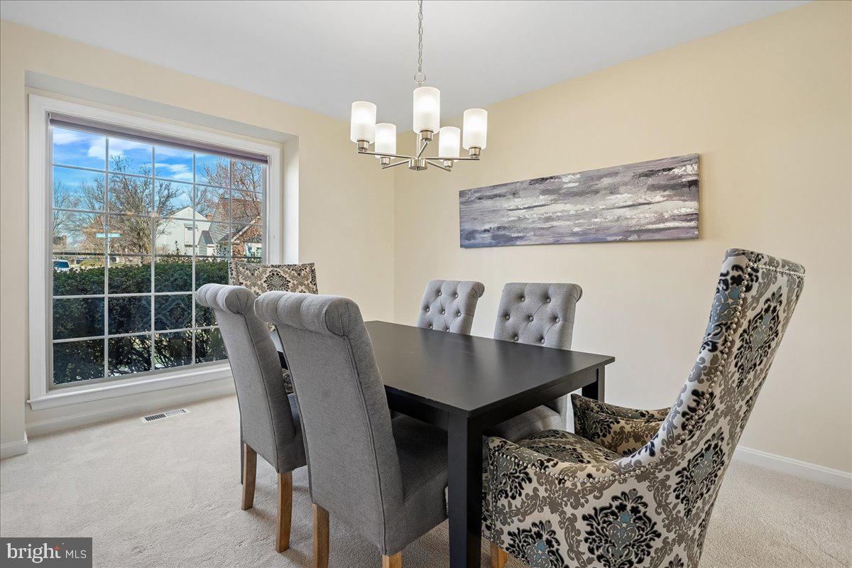 8501 Silverview Drive Lorton, VA 22079 - Photo 29 of 72 a dining room with furniture a window and a chandelier