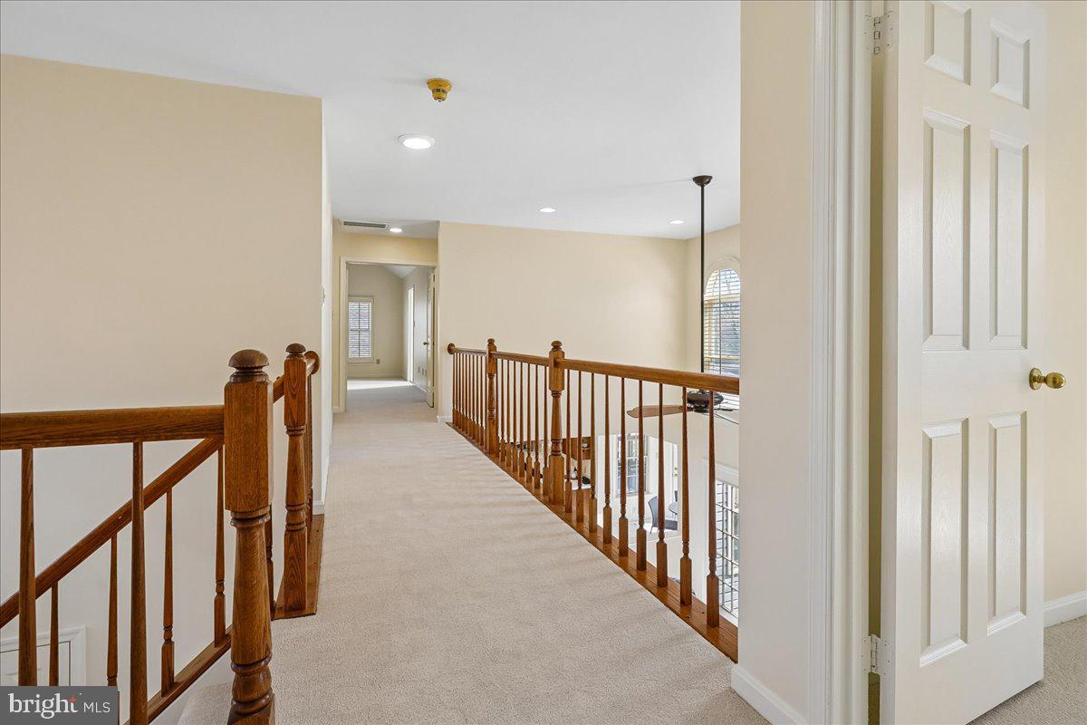 8501 Silverview Drive Lorton, VA 22079 - Photo 34 of 72 a view of a hallway with wooden floor and stairs