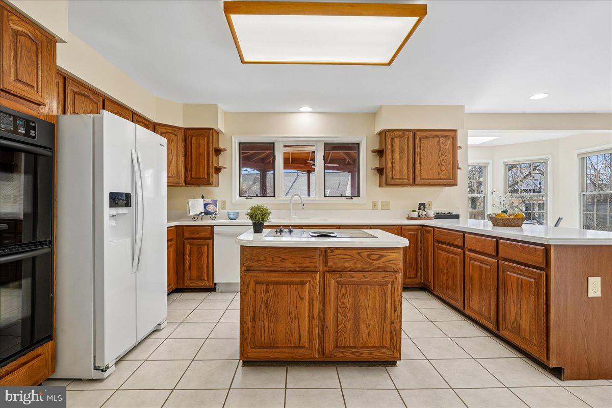 8501 Silverview Drive Lorton, VA 22079 - Photo 5 of 72 a kitchen with stainless steel appliances granite countertop a refrigerator and a stove top oven