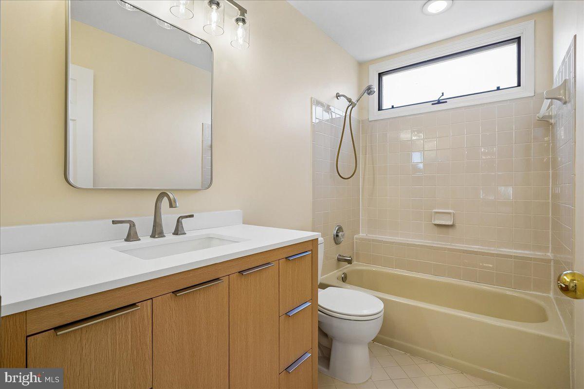 8501 Silverview Drive Lorton, VA 22079 - Photo 53 of 72 a bathroom with a granite countertop bathtub shower sink vanity and toilet