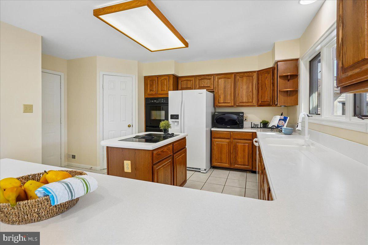 8501 Silverview Drive Lorton, VA 22079 - Photo 8 of 72 a kitchen with stainless steel appliances kitchen island granite countertop a refrigerator and a stove top oven