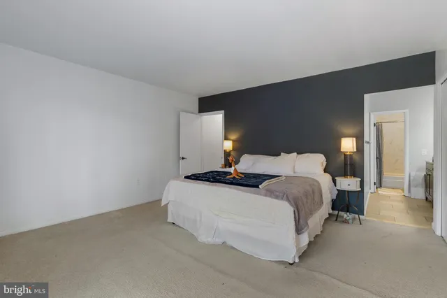 a bedroom with a bed and a lamp