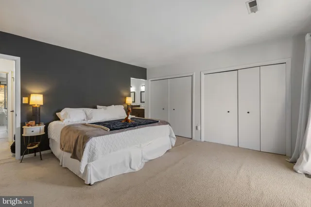 a spacious bedroom with a bed and window