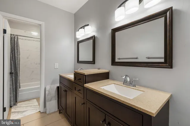 a bathroom with 2 sink and a mirror