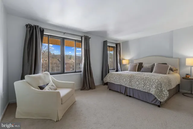 a bedroom with bed and glass window