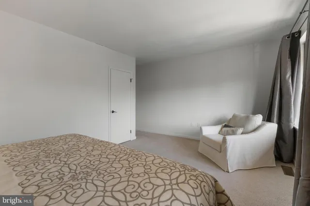 a bedroom with a bed and a couch