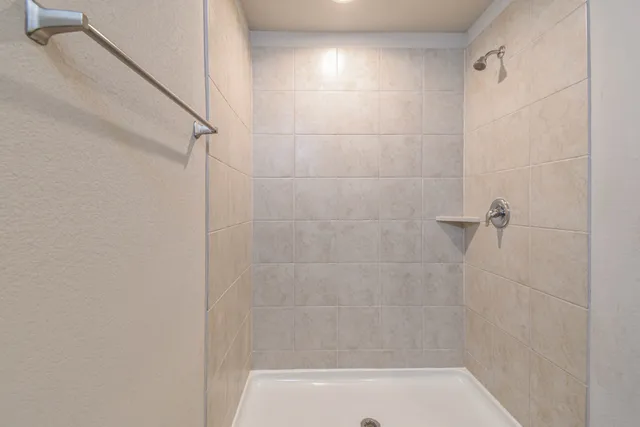 a bathroom with a shower and a bathtub