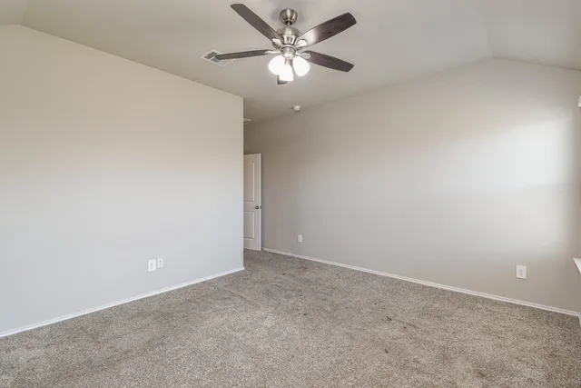 an empty room with a window and a ceiling fan