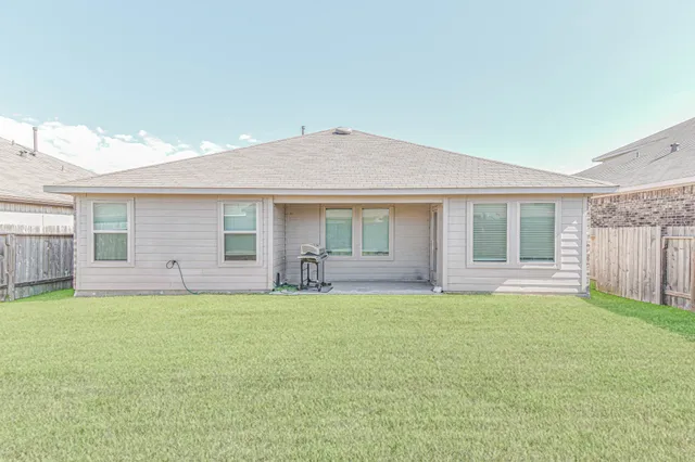 a front view of a house with a garden and yard