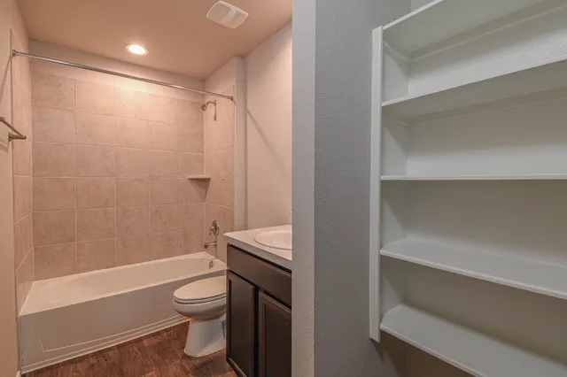 a bathroom with a toilet and a shower