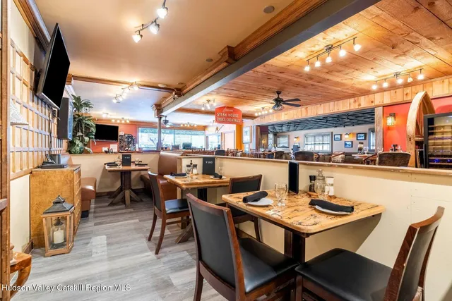 a view of a dining room with furniture water view and a flat screen tv