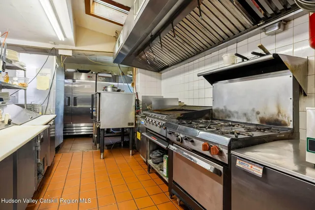 a patio with table and chairs and potted plants