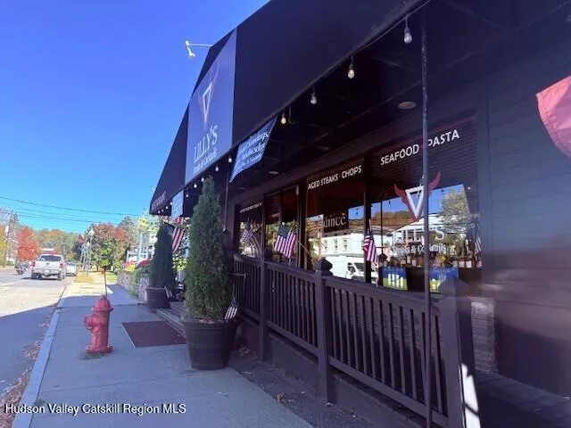 a dining room with furniture a fireplace and wooden floor