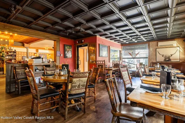 a outdoor dining space with furniture and a view of city