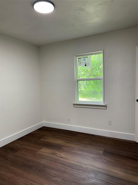 1114 Blackburn Street Commerce, TX 75428 - Photo 12 of 20 a view of a room that has wooden floor and window
