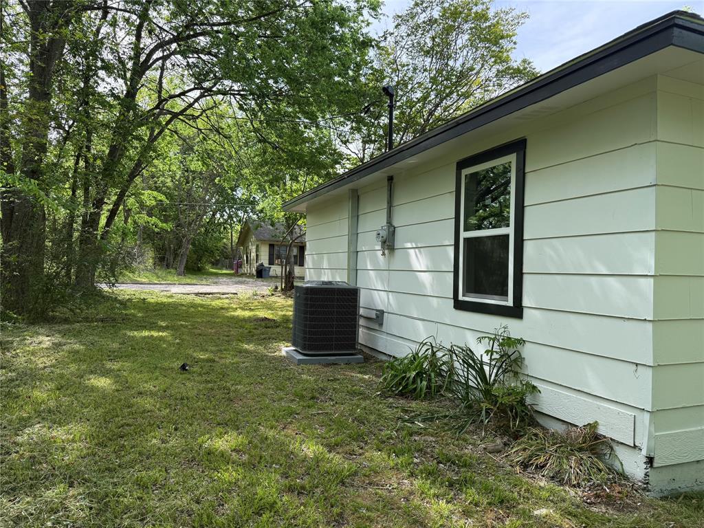 1114 Blackburn Street Commerce, TX 75428 - Photo 17 of 20 a view of backyard of house with green space