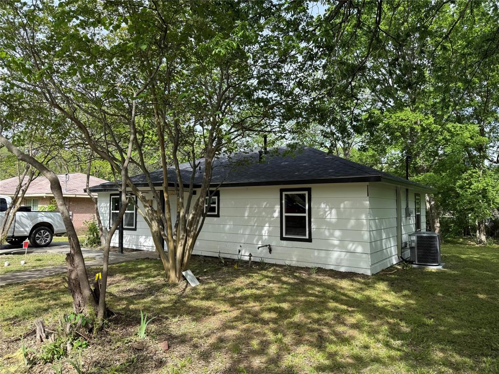 1114 Blackburn Street Commerce, TX 75428 - Photo 19 of 20 a house that has tree in front of it