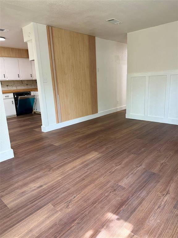 1114 Blackburn Street Commerce, TX 75428 - Photo 5 of 20 a view of a kitchen with wooden floor and a sink