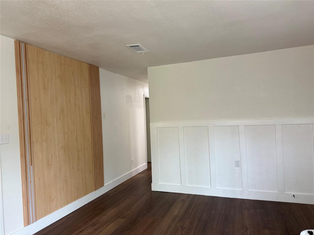 1114 Blackburn Street Commerce, TX 75428 - Photo 6 of 20 a view of an empty room with wooden floor