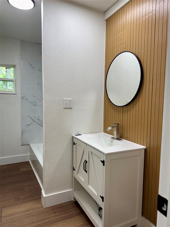 1114 Blackburn Street Commerce, TX 75428 - Photo 8 of 20 a bathroom with a sink and a mirror