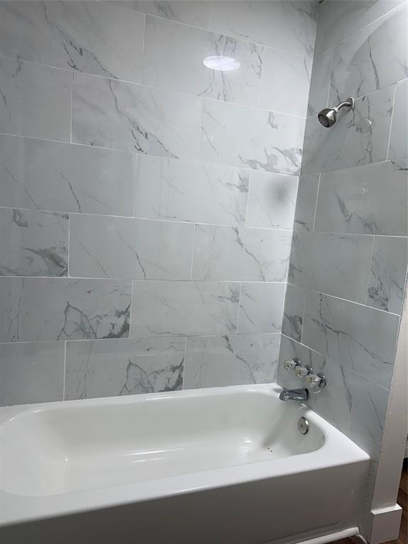 1114 Blackburn Street Commerce, TX 75428 - Photo 9 of 20 a bathroom with a bathtub and shower