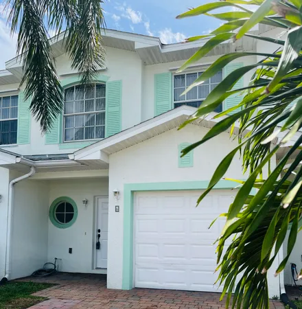 a view of a house with a palm tree