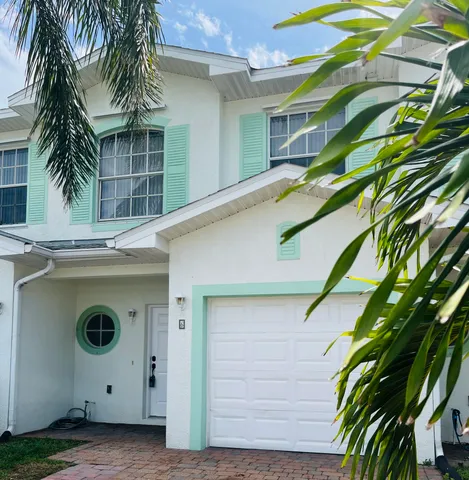 a view of a house with a palm tree