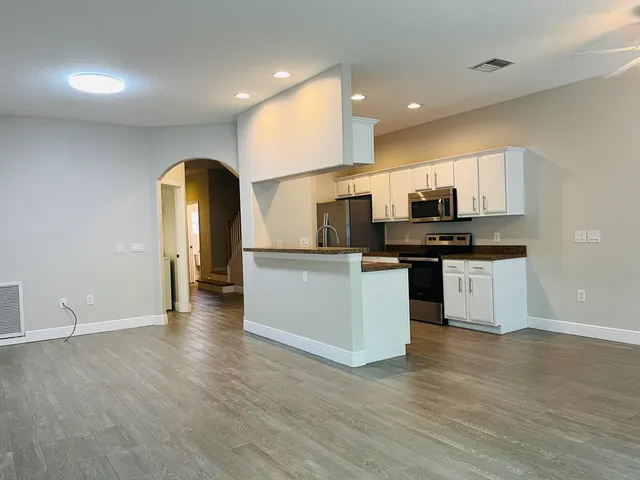 a kitchen with stainless steel appliances a stove top oven and a sink