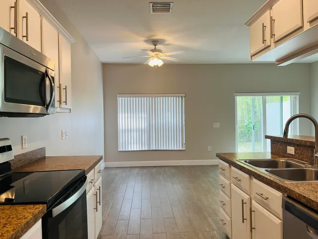 a kitchen with a sink stove and microwave