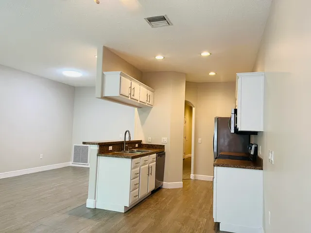 a kitchen with stainless steel appliances a refrigerator and a stove