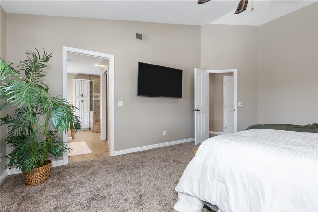 1275 Shane Lane Templeton, CA 93465 - Photo 35 of 70 a spacious bedroom with a bed and a potted plant