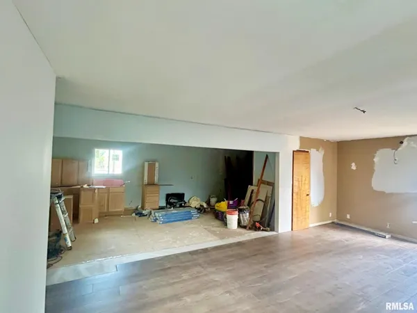 a view of a livingroom with furniture and a gym equipment