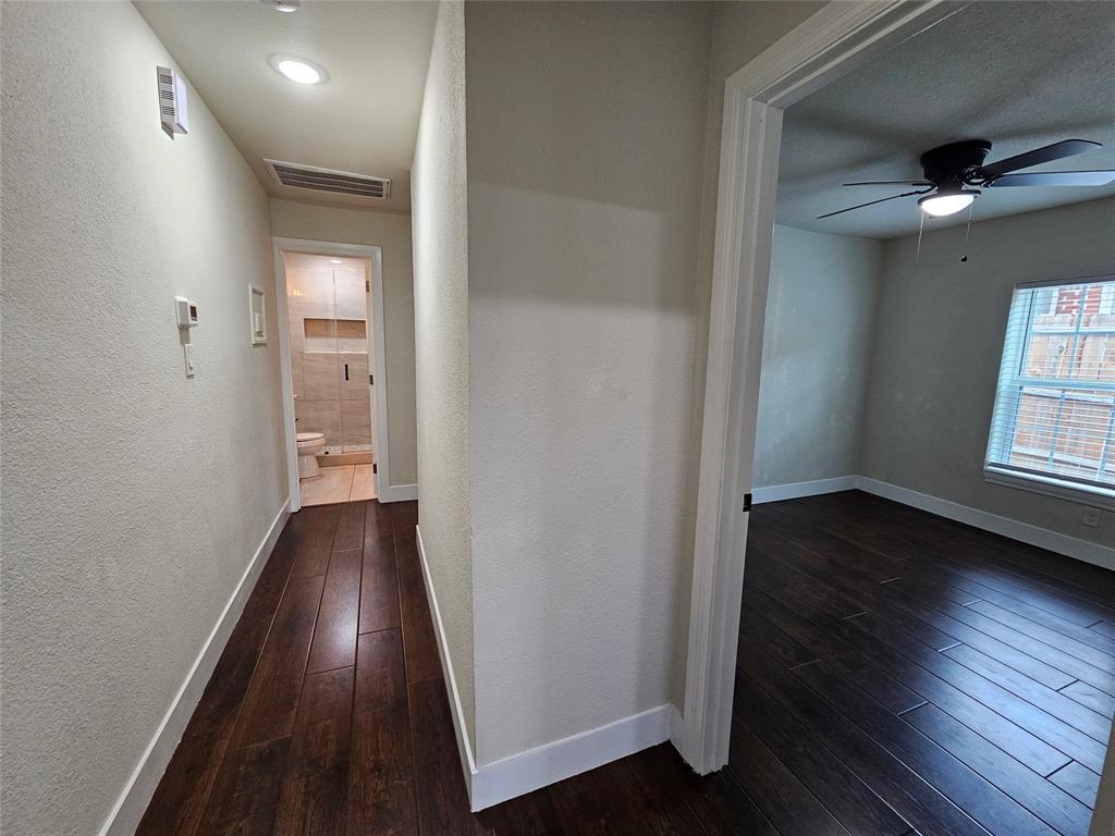 211 North Hampton Road Dallas, TX 75208 - Photo 13 of 22 Hallway featuring wood-finish flooring, recessed lighting, and a bathroom with a tiled shower enclosure