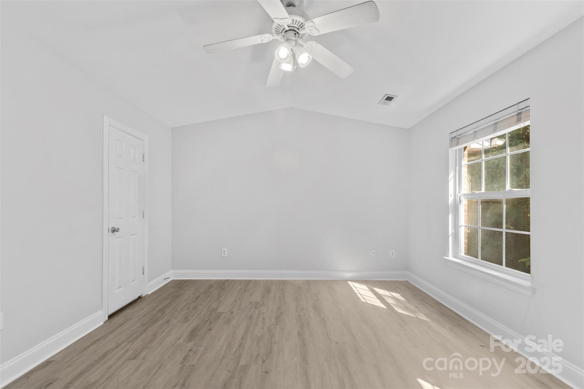 2476 Ryerson Court Charlotte, NC 28213 - Photo 15 of 30 wooden floor in an empty room with a window