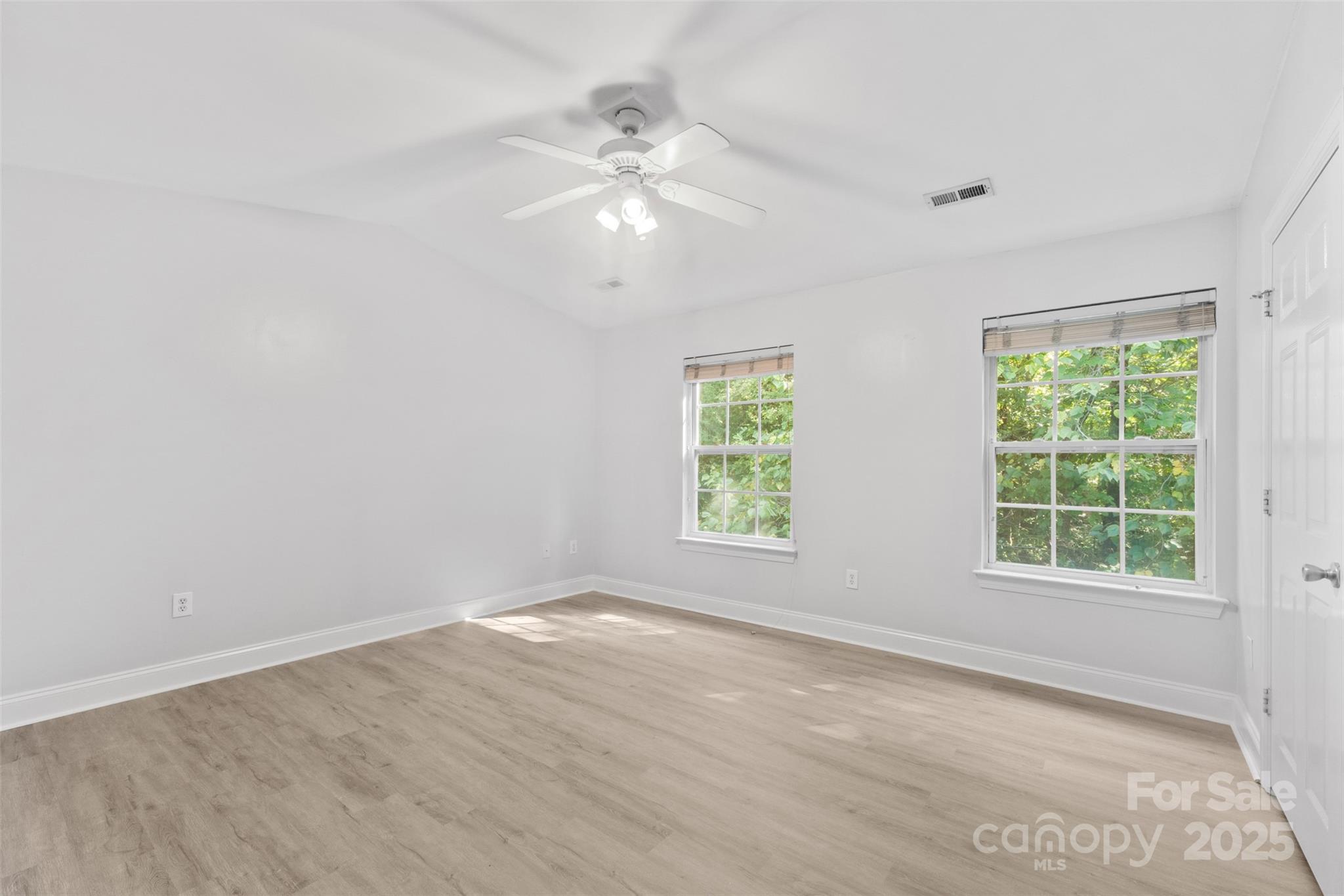 2476 Ryerson Court Charlotte, NC 28213 - Photo 16 of 30 an empty room with windows and chandelier fan