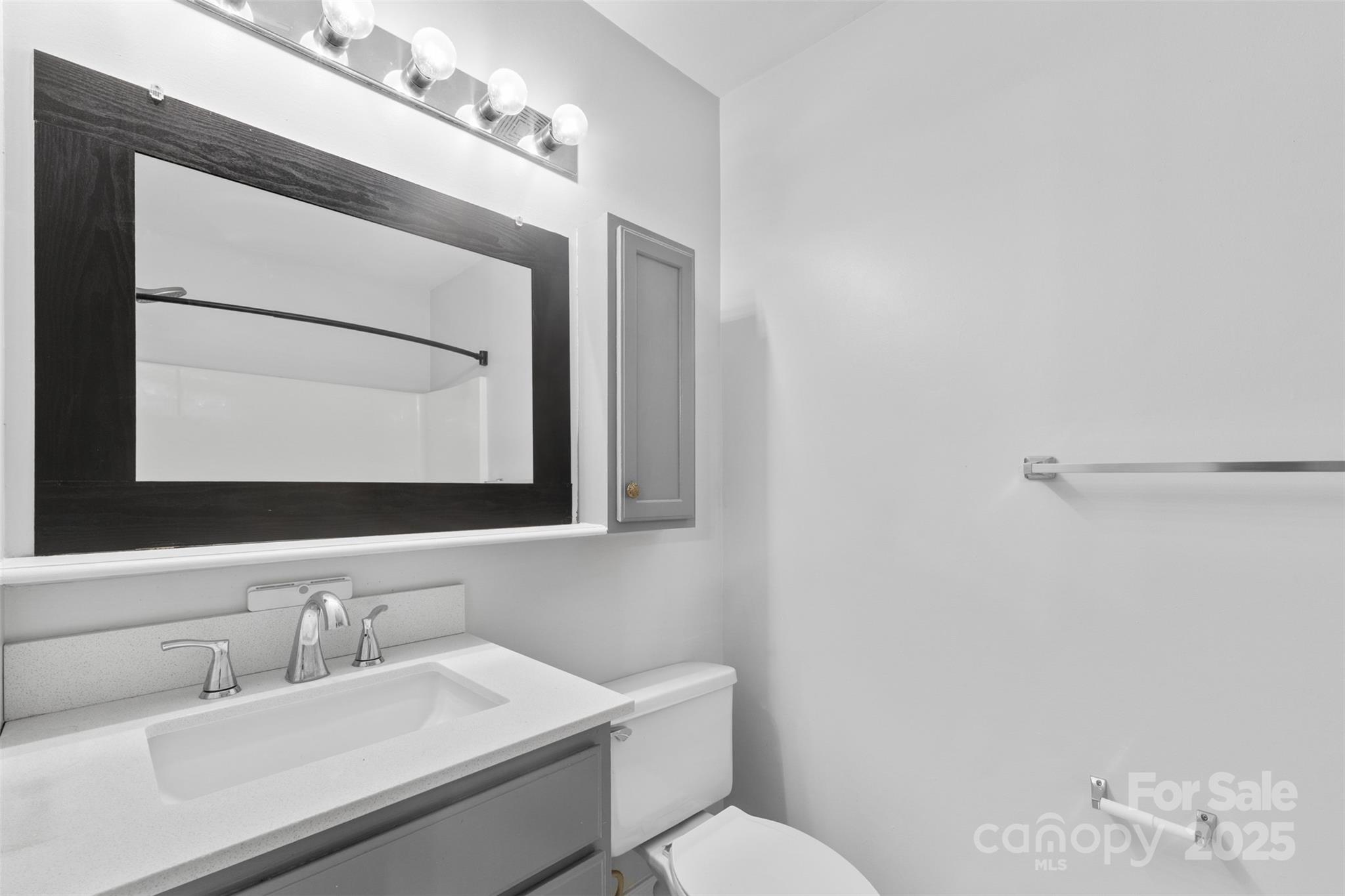 2476 Ryerson Court Charlotte, NC 28213 - Photo 26 of 30 a bathroom with a toilet sink and mirror